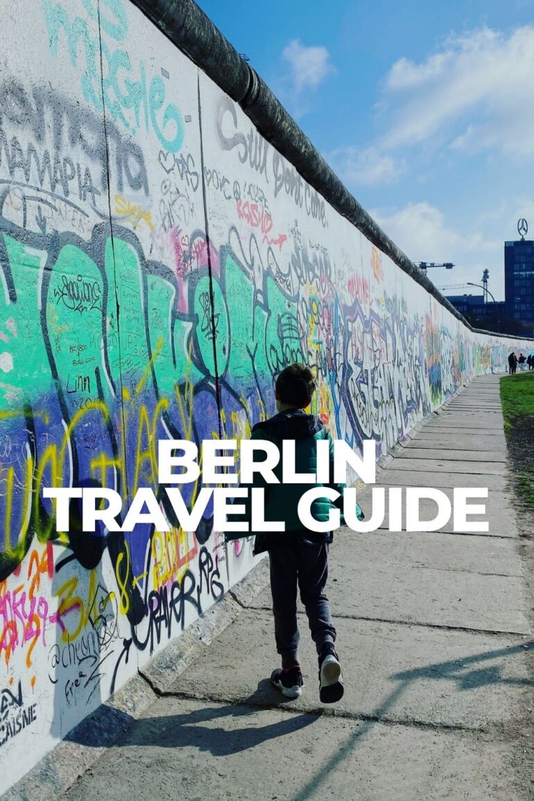 Child walking along the East Side Gallery section of the Berlin Wall in Berlin