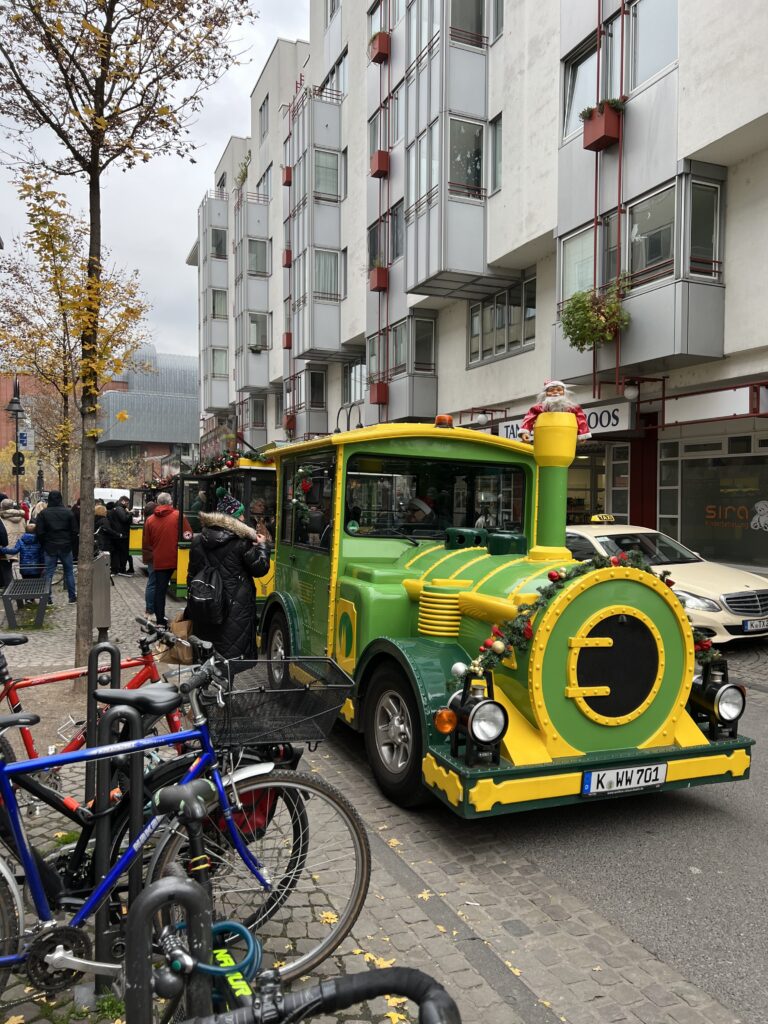 Green and yellow Christmas train connecting the Christmas markets in Cologne