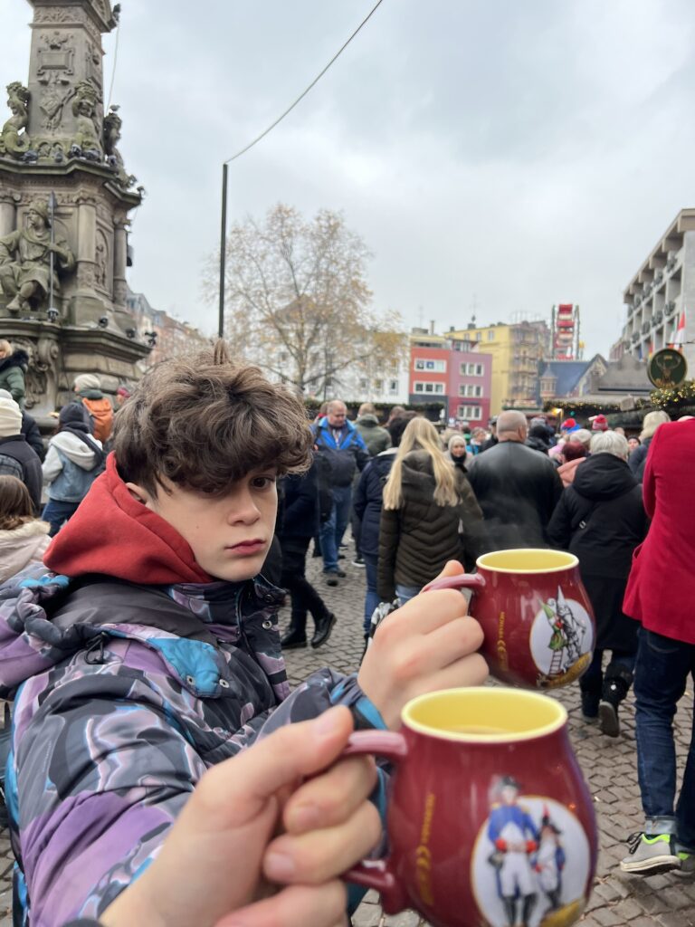Holding Christmas market mugs during our visit to Cologne