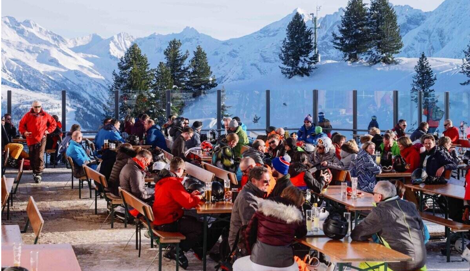 Après-ski party in Mayrhofen, Austria, featuring a crowd of skiers, live music, and festive alpine vibes.