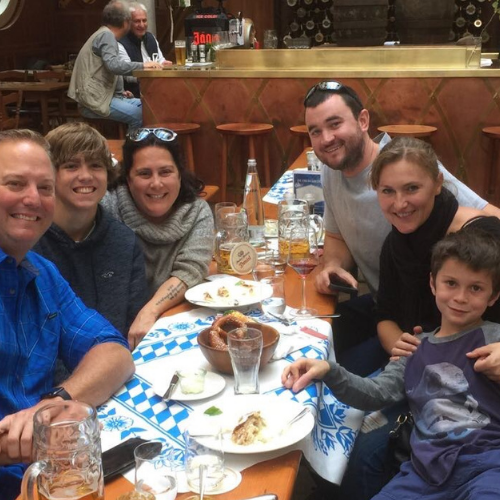 Guests eating at long communal tables inside an Oktoberfest beer tent