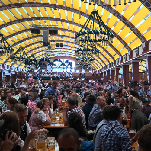 Inside an Oktoberfest beer tent in Munich with decorated ceiling