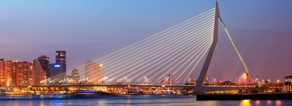 Erasmus Bridge illuminated at night with the Rotterdam