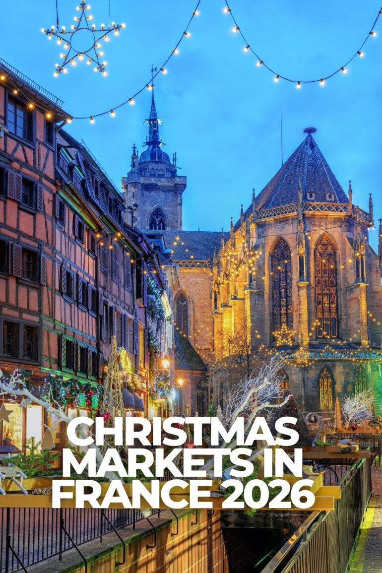 Christmas market in Colmar, France with half-timbered buildings, holiday lights and the historic church in the background