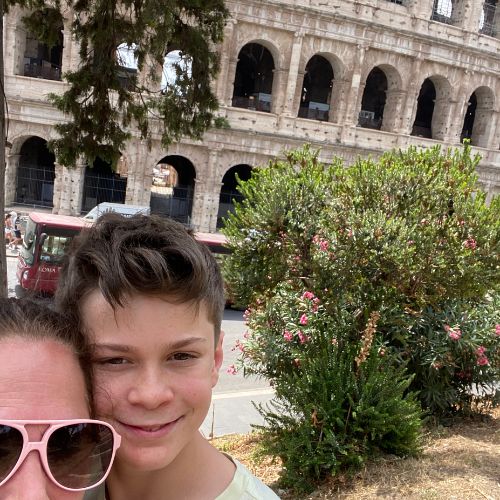 Mother and son taking a selfie in front of the Colosseum in Rome