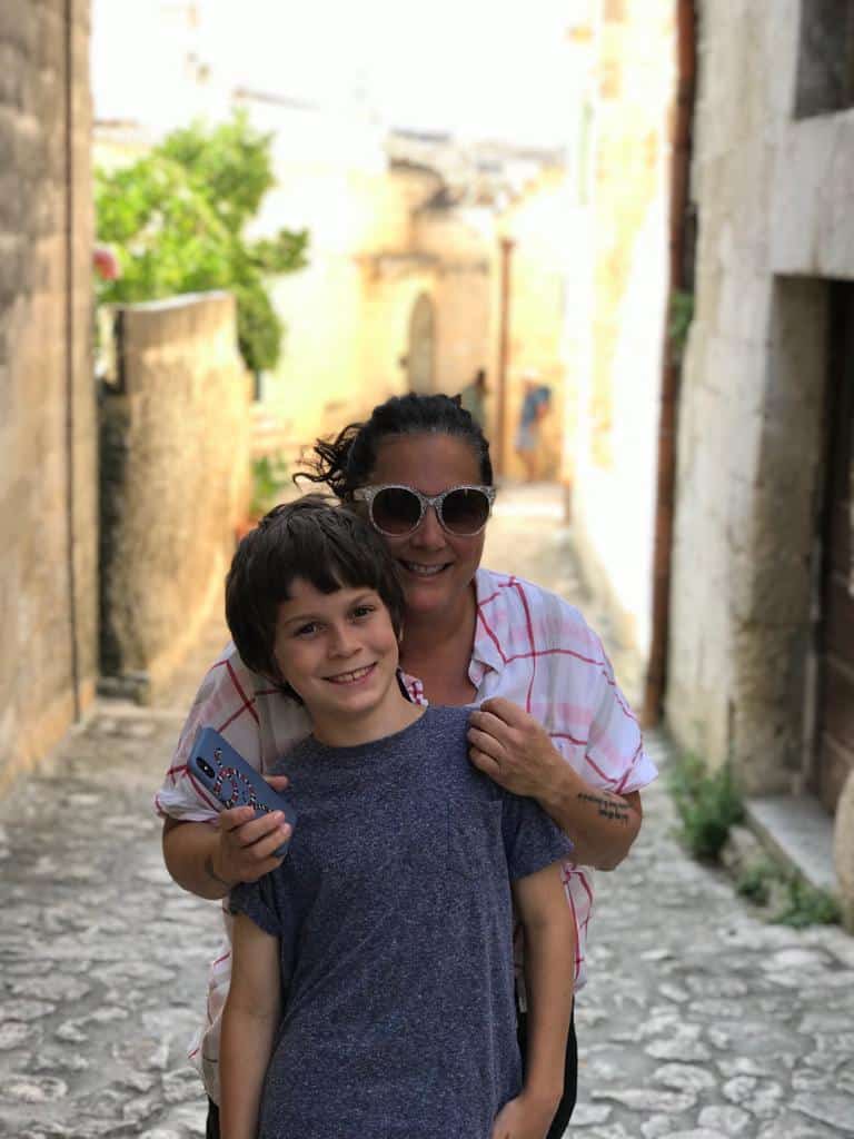 Erin and Dylan walking through the narrow stone lanes of the Sassi