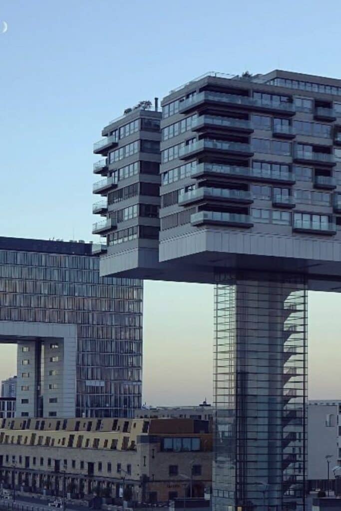 The Rheinauhafen crane buildings at dusk along the Rhine in Cologne, home to Michelin-starred Ox and Klee