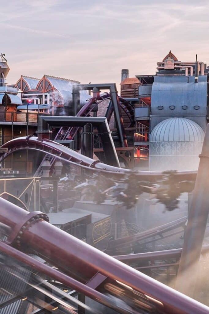 The F.L.Y. flying coaster launching through the immersive steampunk Rookburgh themed area at Phantasialand Germany with industrial pipes and Victorian machinery