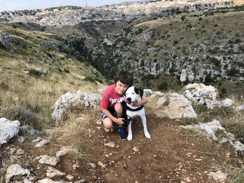 Dylan and dog Cash at the Belvedere viewpoint looking across to Matera Italy