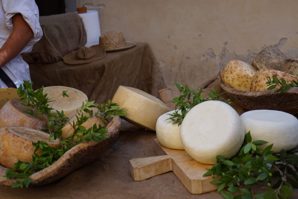 Cheese-making demonstration at a market stall during Volterra AD 1398