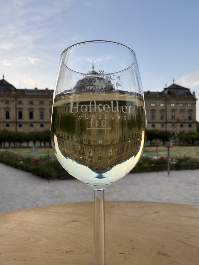 Glass of Franconian wine overlooking the gardens of the Würzburg Residence