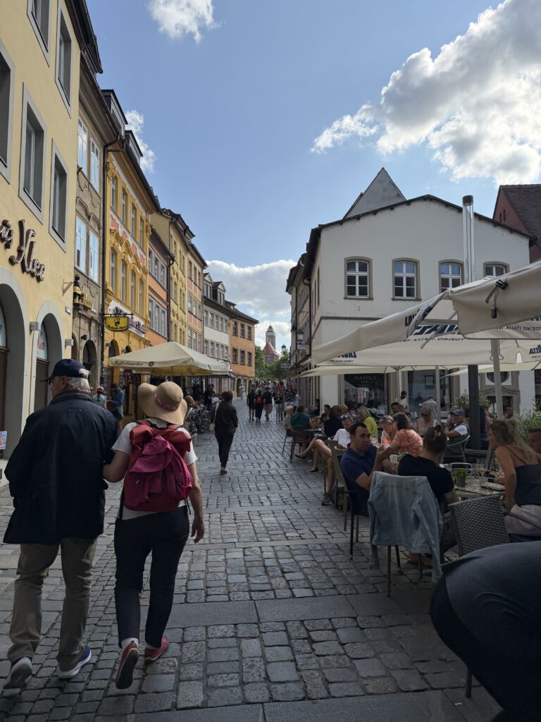 Cobblestone street in Bamberg’s Old Town lined with colorful yellow and orange buildings