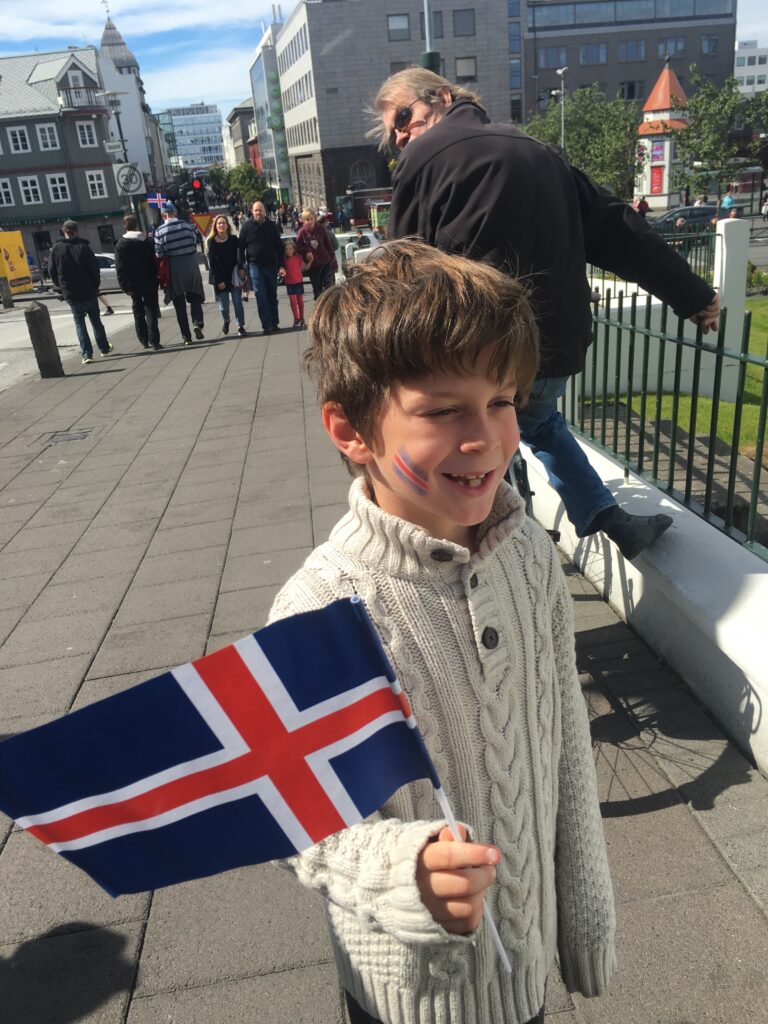 Dylan holding an Icelandic flag in Reykjavik during Euro 2016