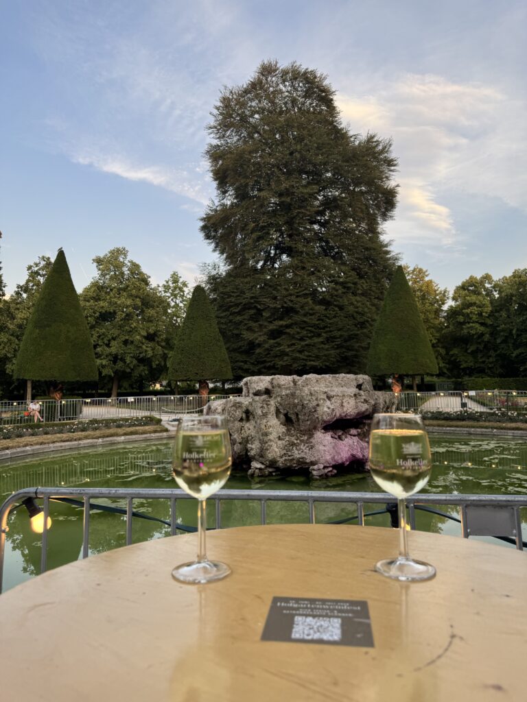 Two glasses of Franconian white wine on a stone ledge in the Würzburg Residence garden.