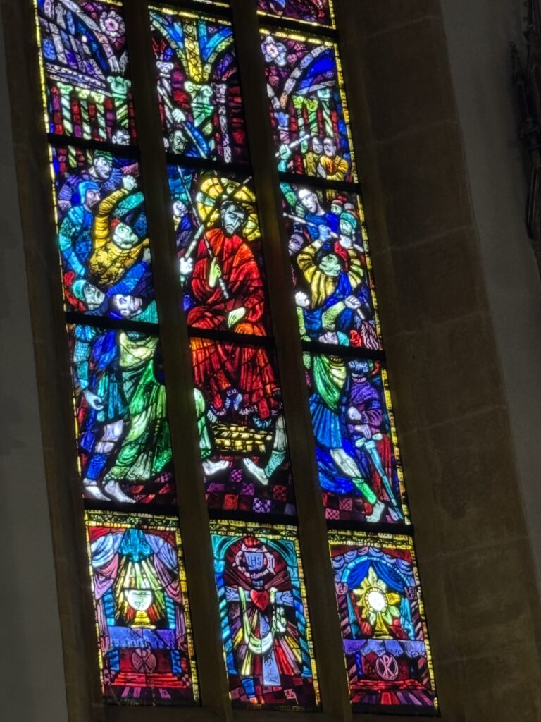 Colorful stained glass window inside Graz Cathedral with Hitleer and Mussolini