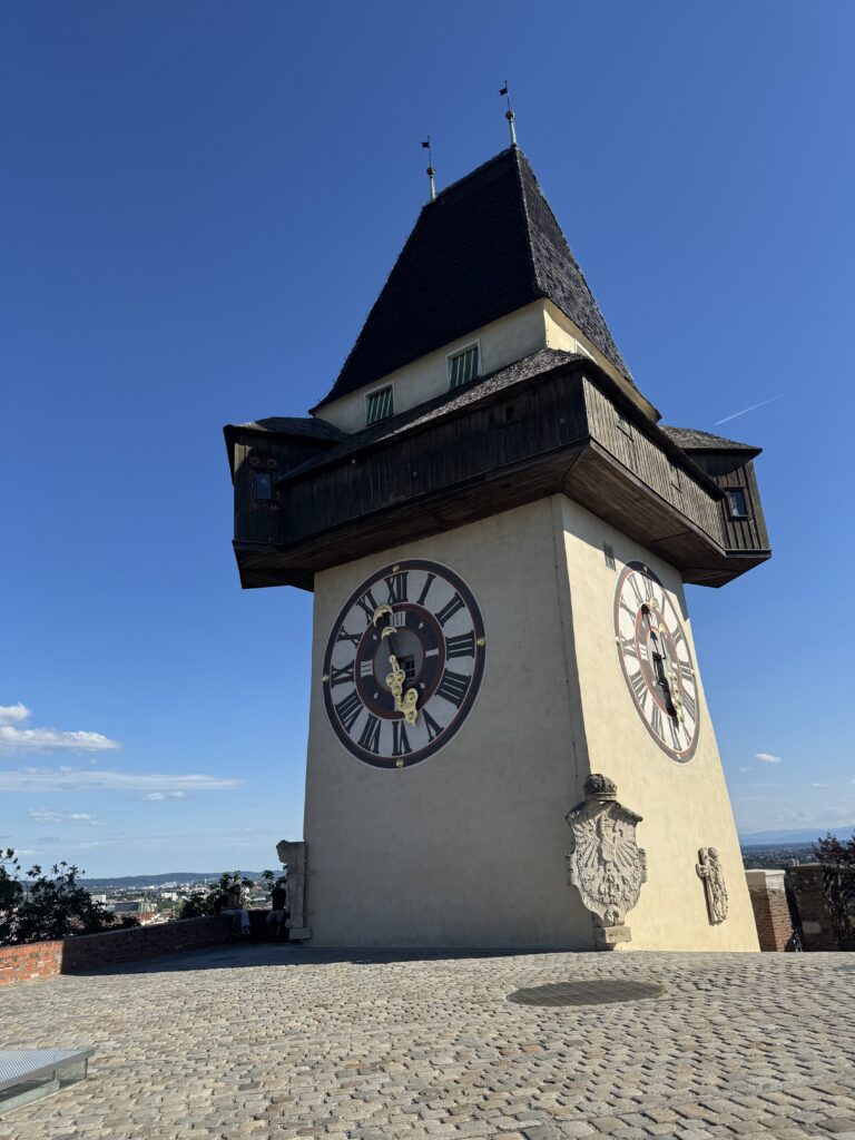 The historic Graz Clock Tower overlooking the city from Schlossberg