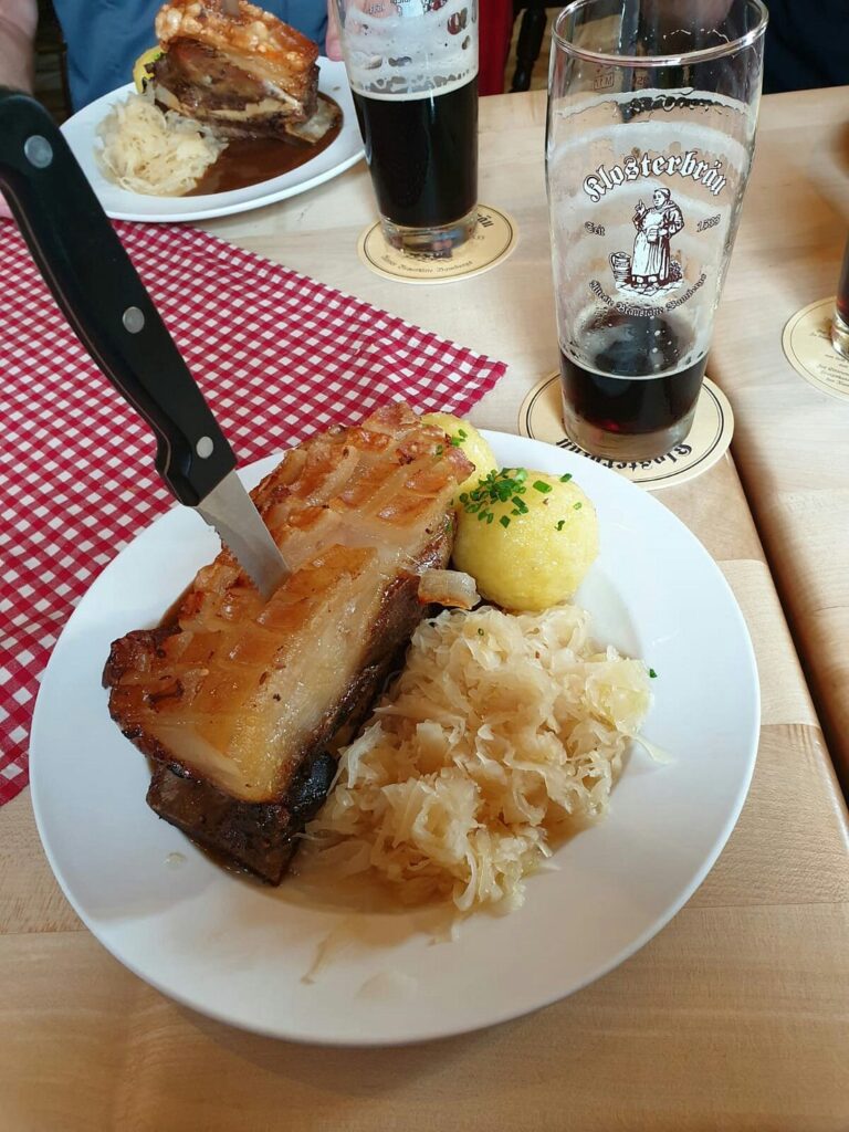 Pork belly with sauerkraut, potato dumpling and dark beer at Klosterbräu in Bamberg