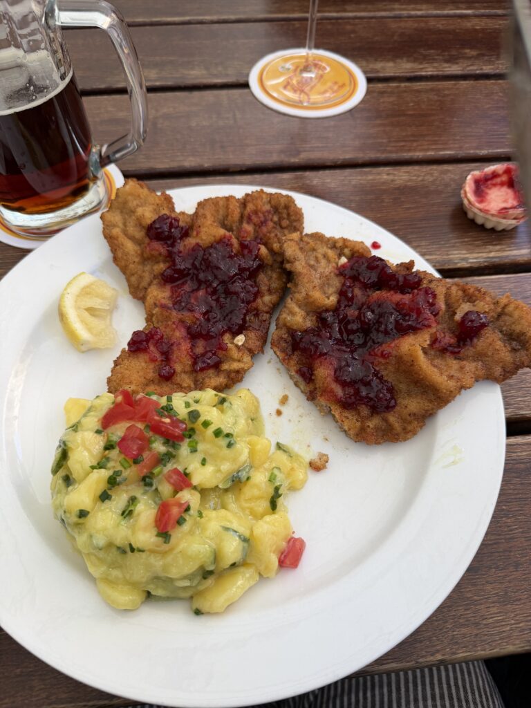 Veal Wiener schnitzel with potato salad and lingonberry sauce served in Bamberg