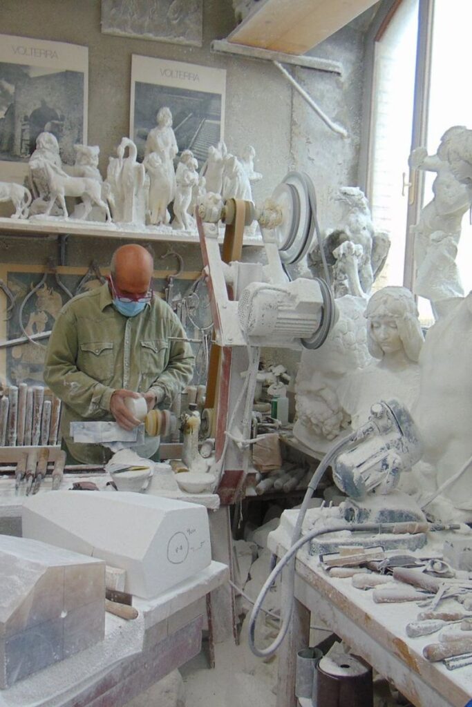 Artisan carving alabaster in a traditional Volterra workshop