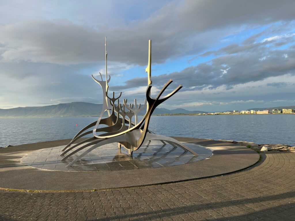 Sun Voyager sculpture on the Reykjavik waterfront with mountains across the bay