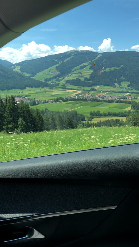 Green mountain valley in South Tyrol seen from our car while driving through the Dolomites