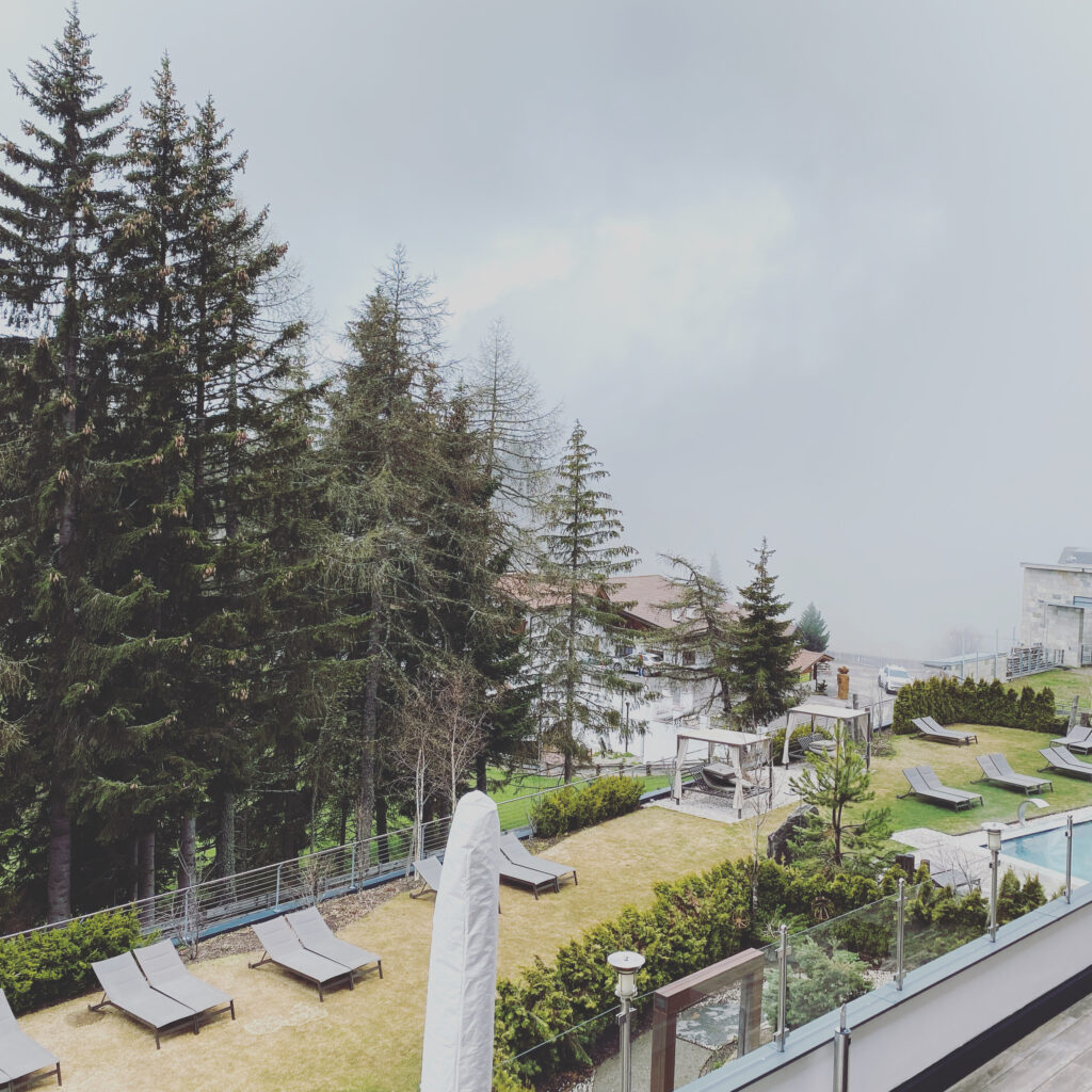 Snow around a mountain hotel and outdoor pool in South Tyrol in winter