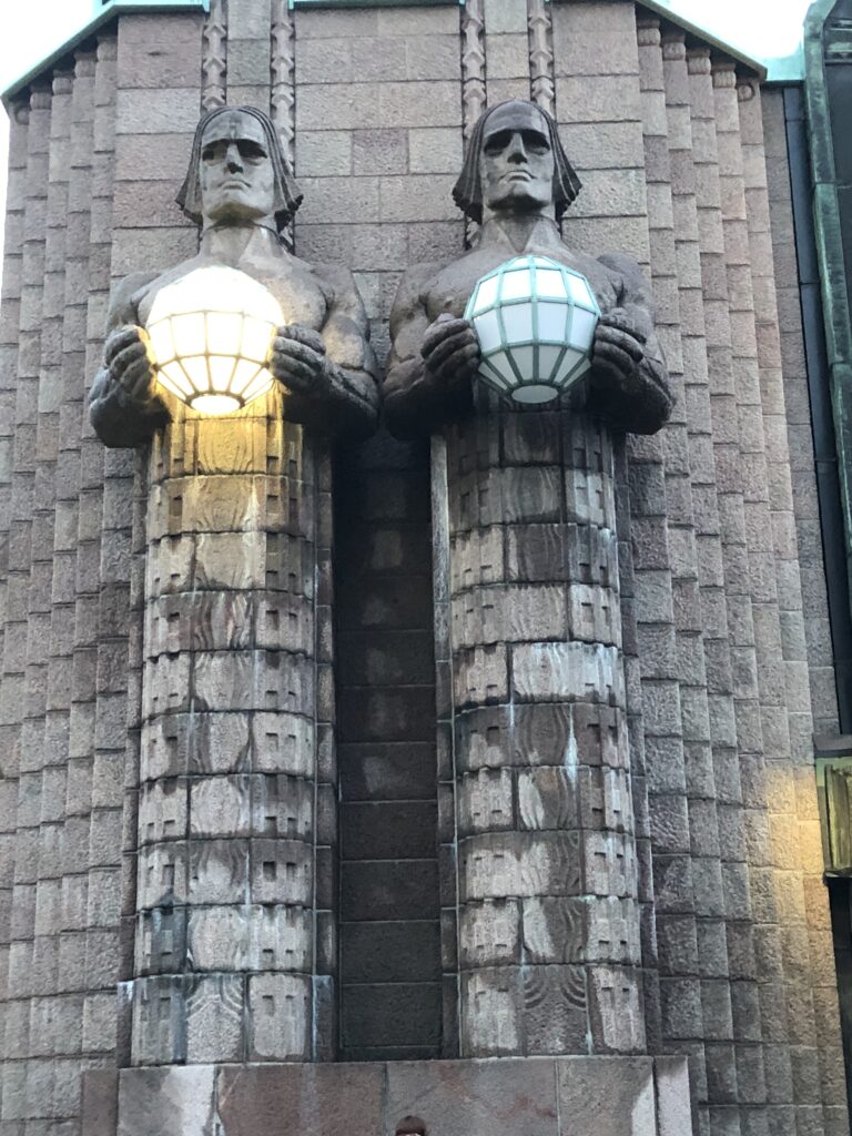 Stone lantern carrier statues outside Helsinki Central Station