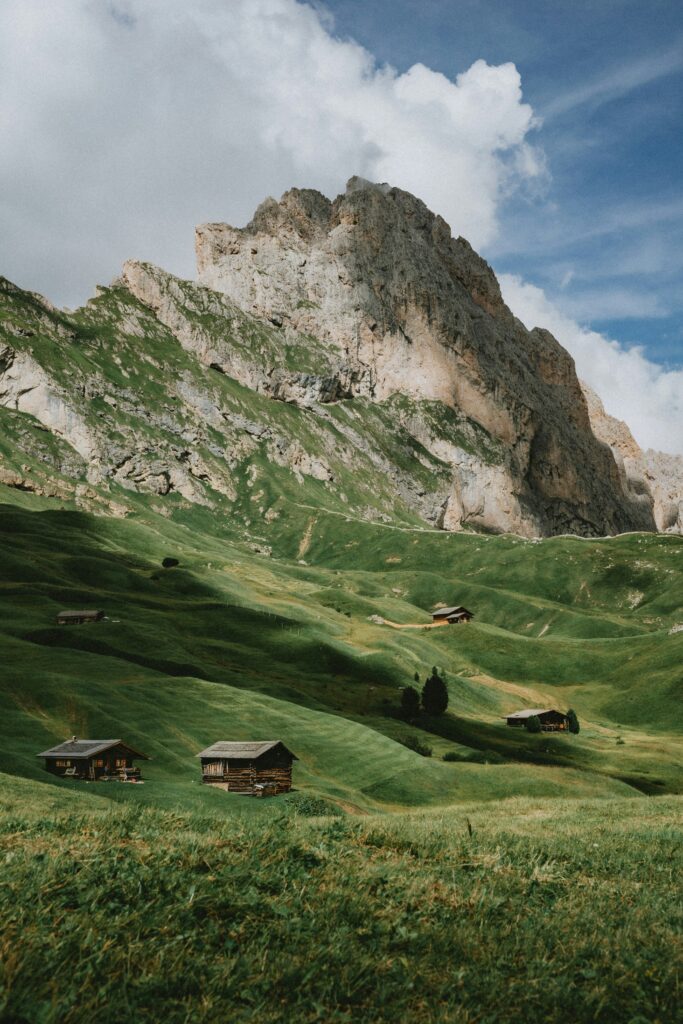 Jagged peaks of Seceda above the green slopes of Val Gardena in the Dolomites