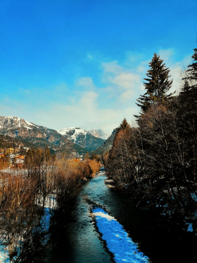Mountain peaks and green valley scenery in Val di Fassa in the Dolomites