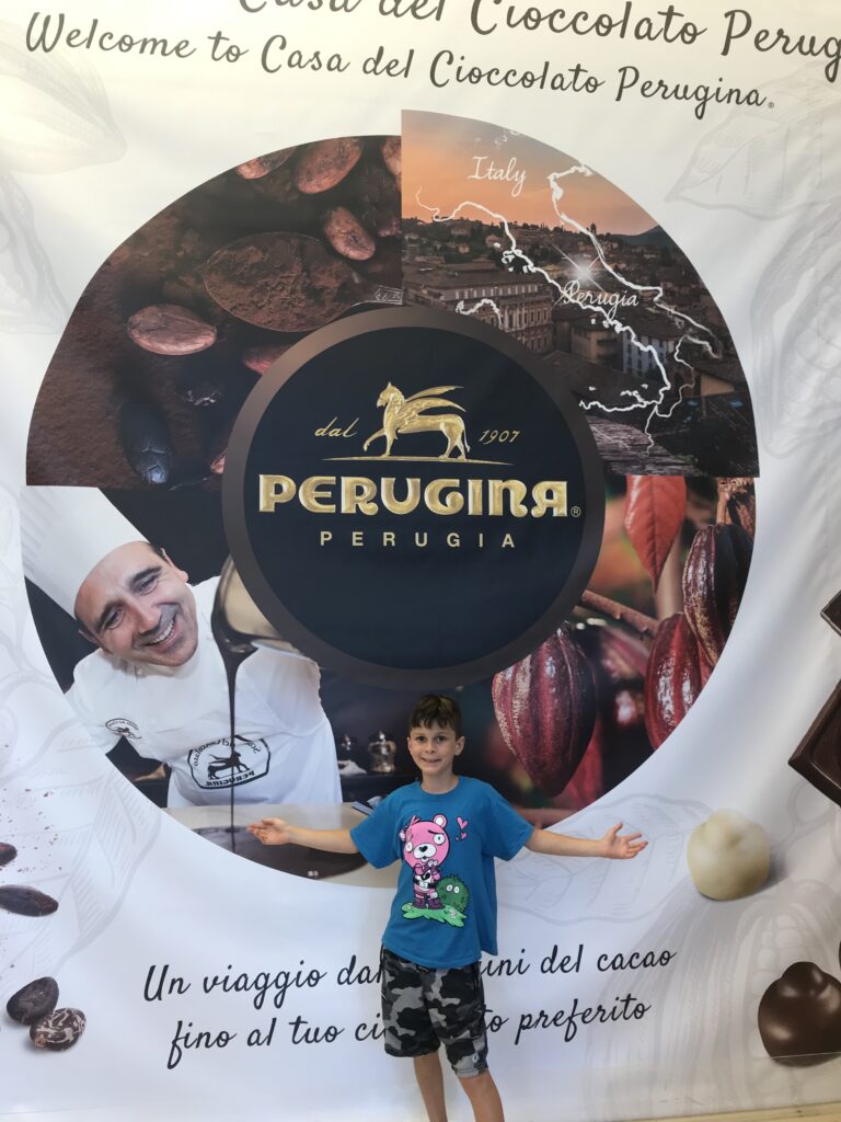 Child standing in front of the Perugina chocolate display at Casa del Cioccolato in Perugia