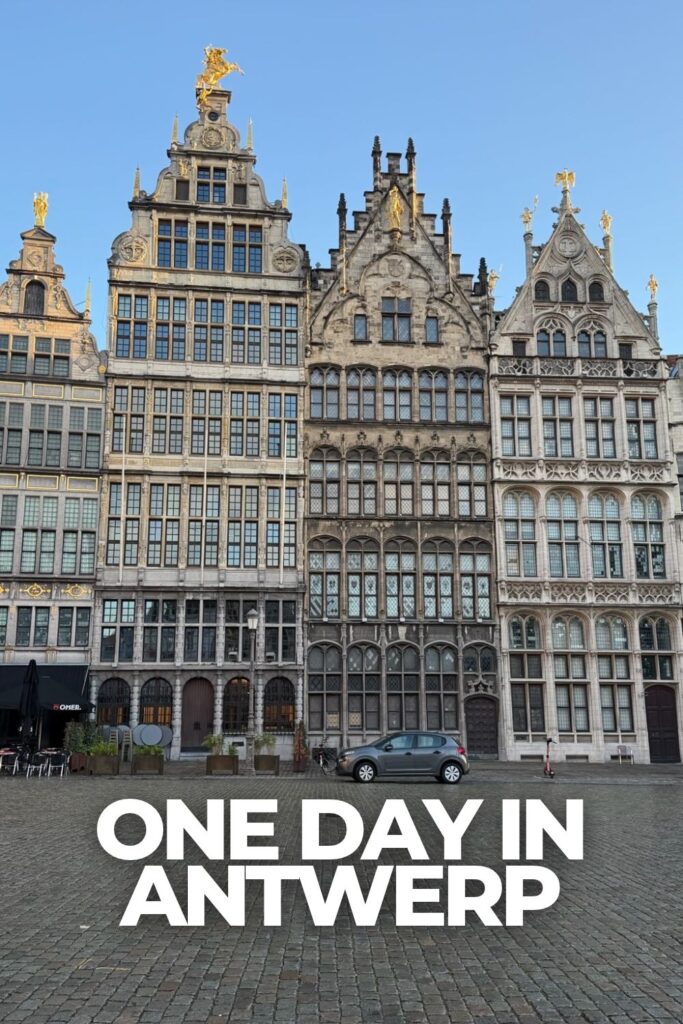 Historic buildings overlooking Grote Markt in Antwerp, Belgium, with ornate facades against a clear blue sky.