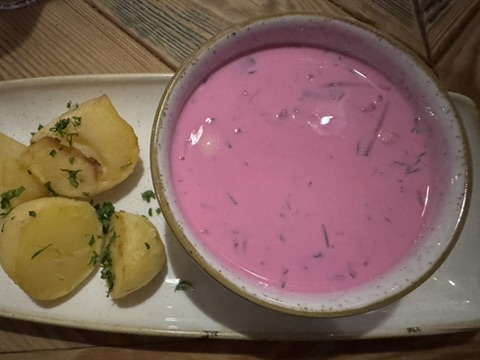 Bright pink šaltibarščiai cold beet soup with roasted potatoes at Etno Dvaras in Vilnius Old Town